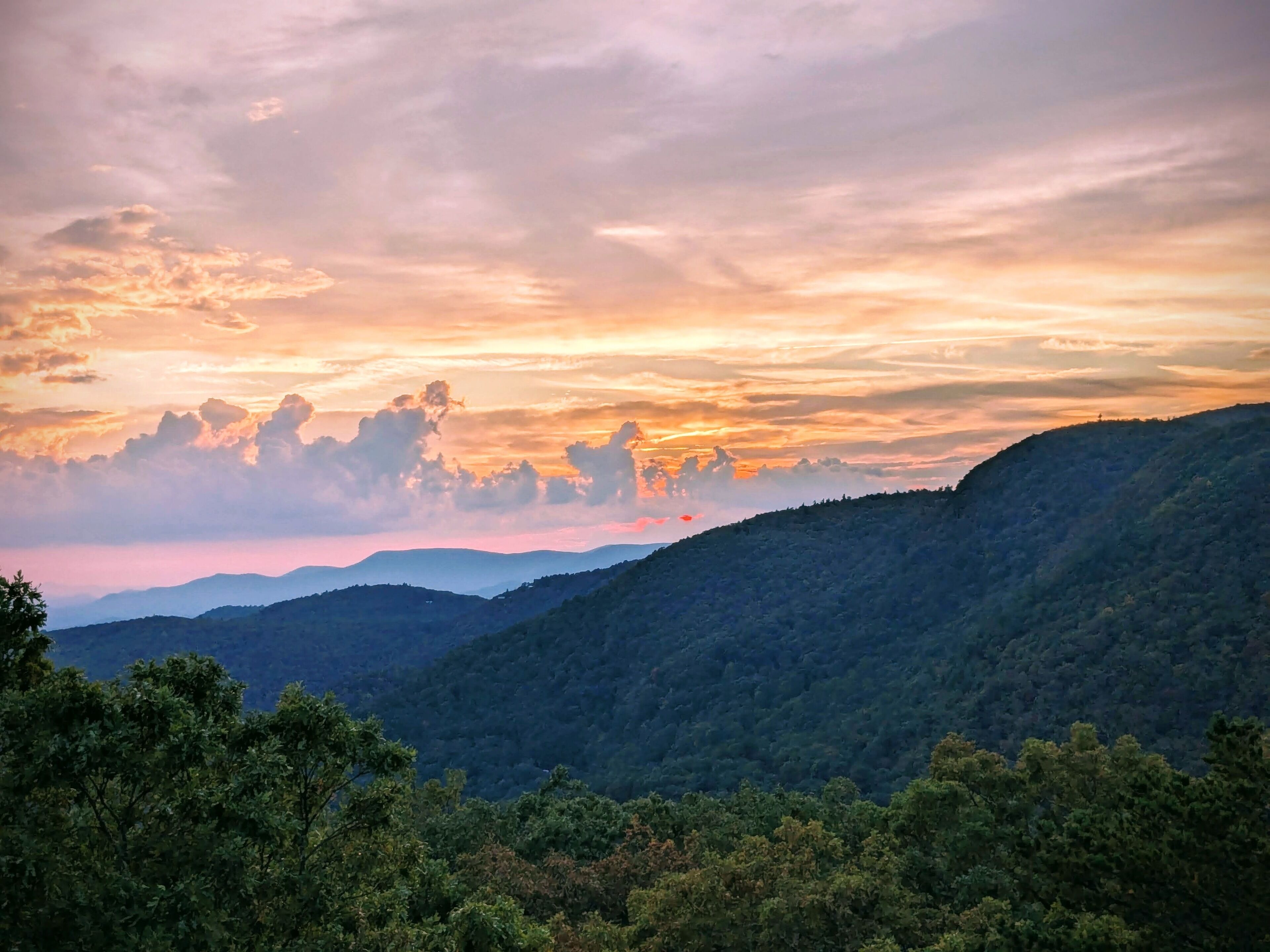 A mountainous landscape with a sunset.