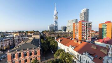 Un paisaje urbano con un moderno rascacielos destacado, edificios históricos y una combinación de estructuras residenciales y comerciales.