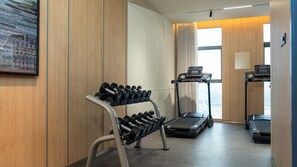 A gym with dumbbells, treadmills, and a wall-mounted TV. - Holiday Inn Express Kunming Changshui Airport by IHG (Kunming)