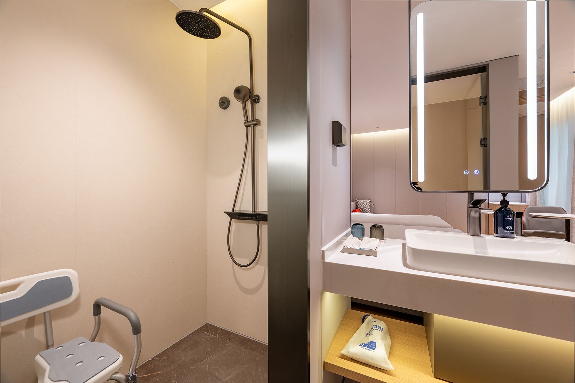 A modern bathroom with a shower, a sink, a mirror, and a chair.