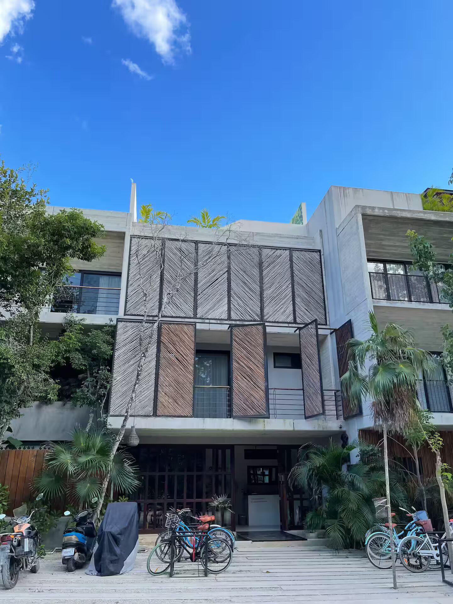 A modern building with a unique facade featuring vertical slats and large windows.
