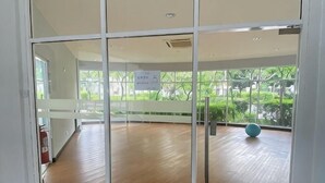 A room with a wooden floor, large windows, and a blue exercise ball. - Casa Budi Dwiputra 15 Putrajaya (Putrajaya)