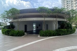 A modern building with a curved facade, surrounded by greenery and a paved walkway. - Casa Budi Dwiputra 15 Putrajaya (Putrajaya)