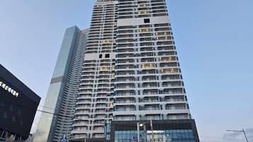 A high-rise building with multiple floors, large windows, and a modern architectural design.