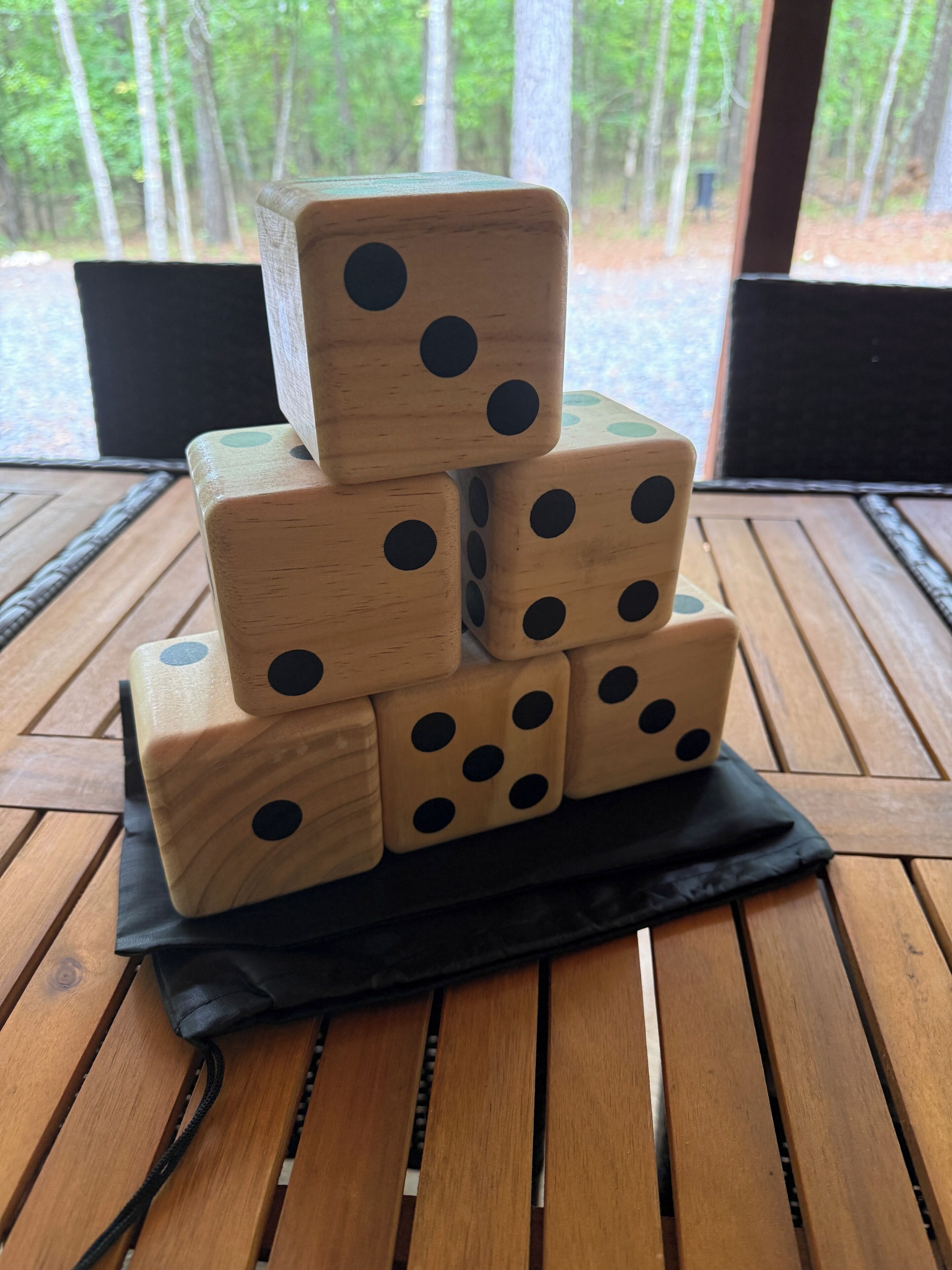 Ein Stapel Holzwürfel auf einem schwarzen Tuch auf einem Holztisch.
