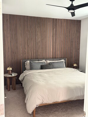 A bedroom with a bed, a round nightstand, a lamp, and a ceiling fan. - •NEW- Stylish 3-Bedroom, 2-Bath Oasis with Pool – Comfort & Relaxation in One! (Queen Creek)