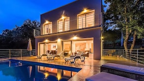 A modern two-story house with a swimming pool, outdoor seating, and a well-lit entrance. - Cozy home in Cetina with private swimming pool, can be inside or outside (Cetina)