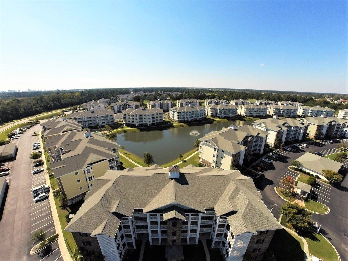 A residential complex with multiple apartment buildings arranged around a central courtyard.