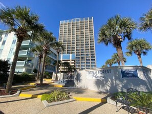 A tall building with balconies and a sign reading "Ocean Forest Plaza". - 2 level Oceanview Penthouse across from ocean! (Myrtle Beach)