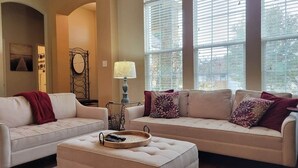 A living room with two sofas, a coffee table, and a lamp.