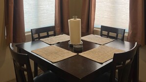A dining room with a table, chairs, and a candle centerpiece. - Private Suite Near Lake Powell | Antelope Canyon (Page)