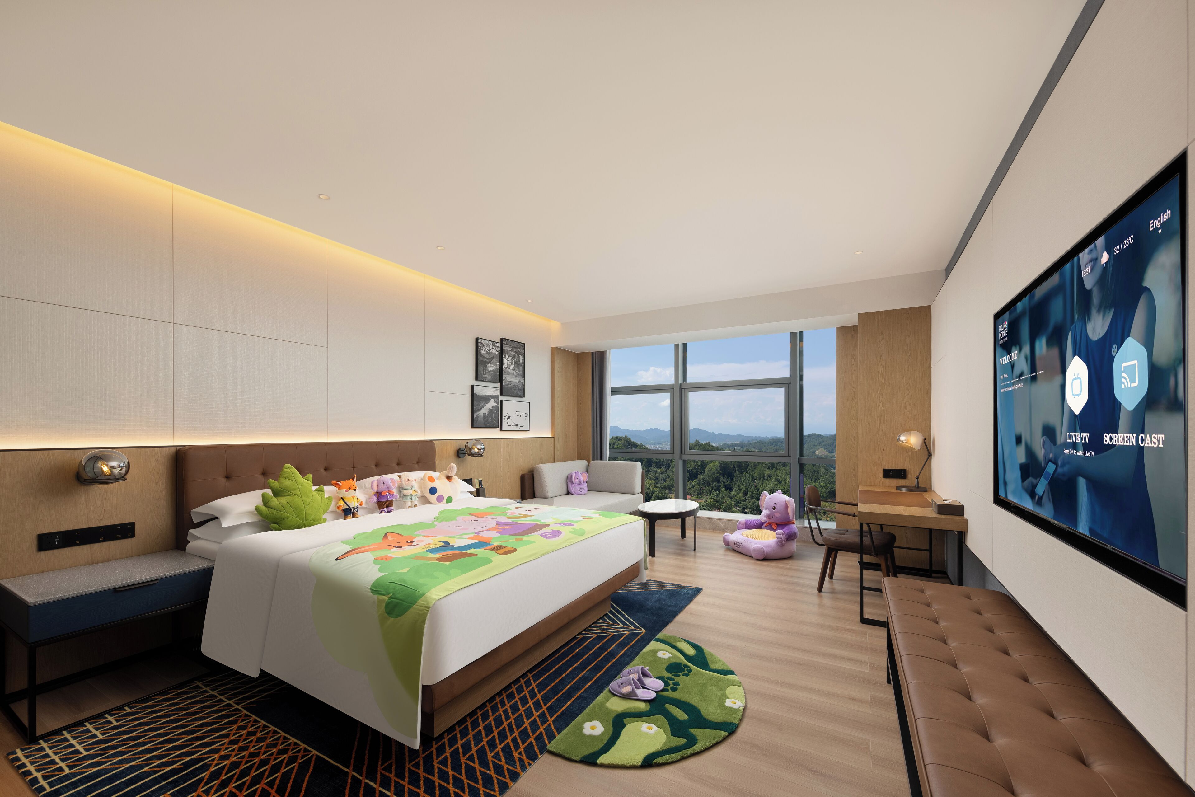 A modern hotel room with a large bed, a desk, a TV, and a view of the outdoors.