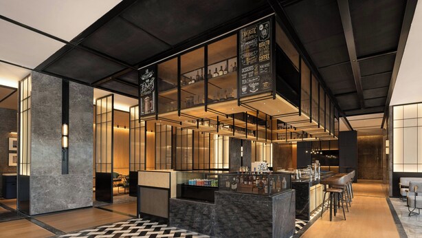Un área de bar moderna con mostrador, taburetes y suelo estampado.