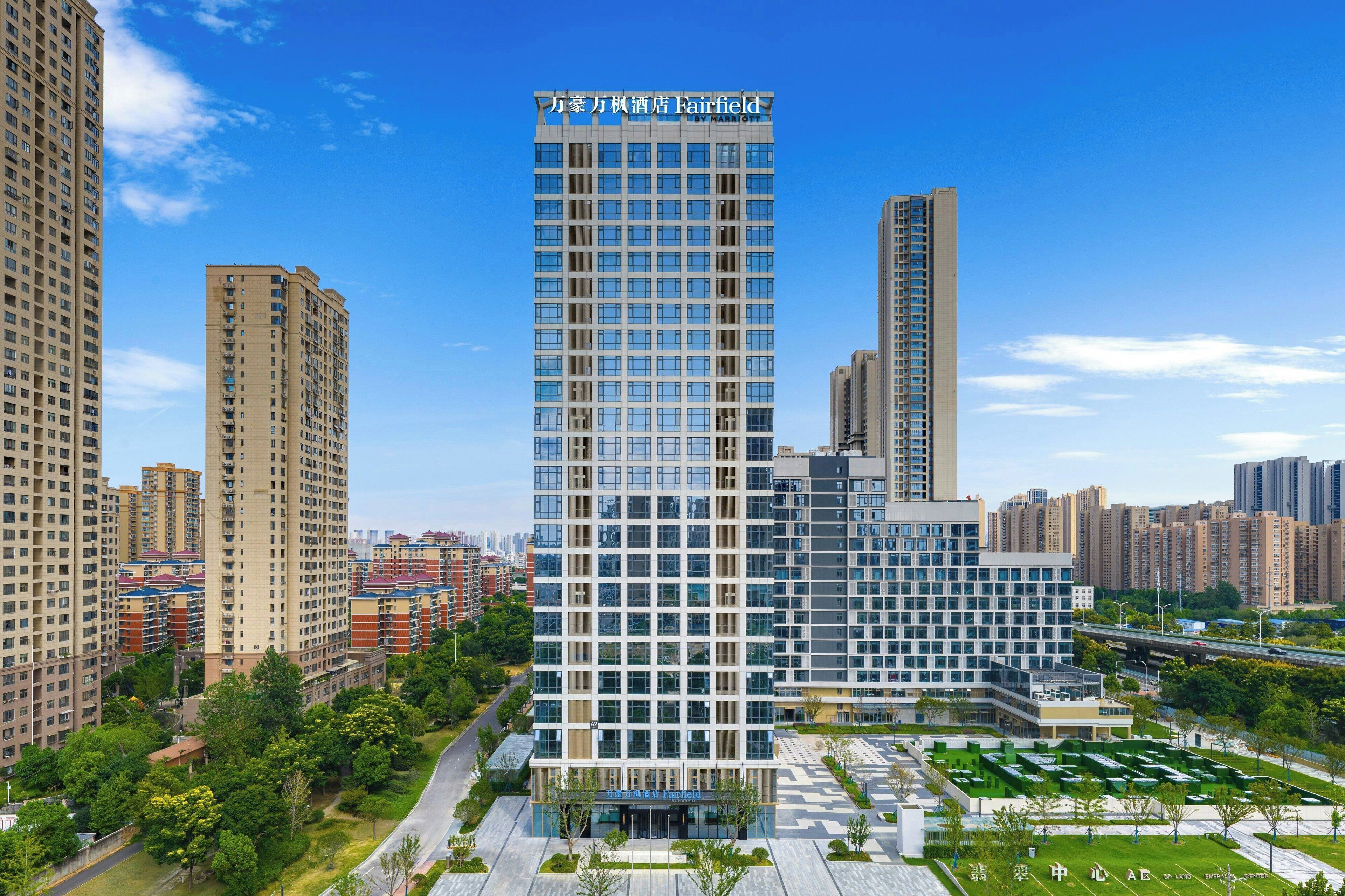 A high-rise hotel with a modern design, featuring a prominent sign at the top.