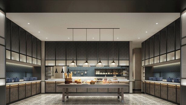 Une cuisine moderne dotée d’un îlot central, de luminaires suspendus et d’un dosseret orné d’un motif en chevrons.
