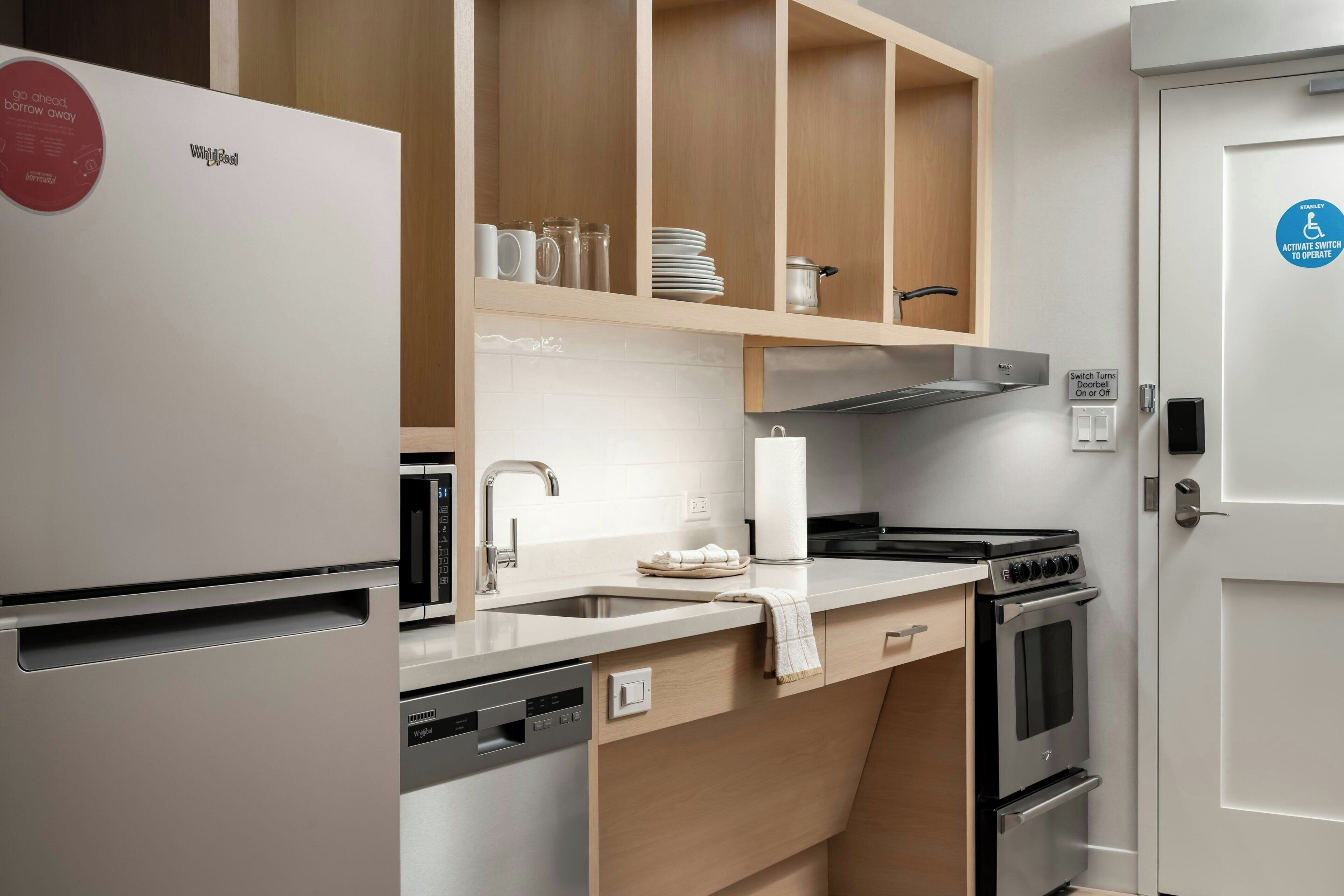 A modern kitchen with a built-in dishwasher, a stove, and wooden cabinets.
