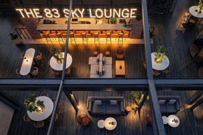 A modern lounge with multiple seating areas, a bar, and a neon sign reading "THE 83 SKY LOUNGE". - Four Points By Sheraton Kinshasa (Kinshasa)