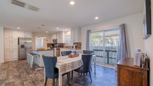 A modern kitchen with white cabinets, a built-in oven, and a dining area with a table and chairs. - The Salsbury Star- large family home, downtown location, pet friendly (Cody)