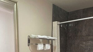 A bathroom with a toilet, sink, and bathtub. - Western Skies Motel (Seagoville)