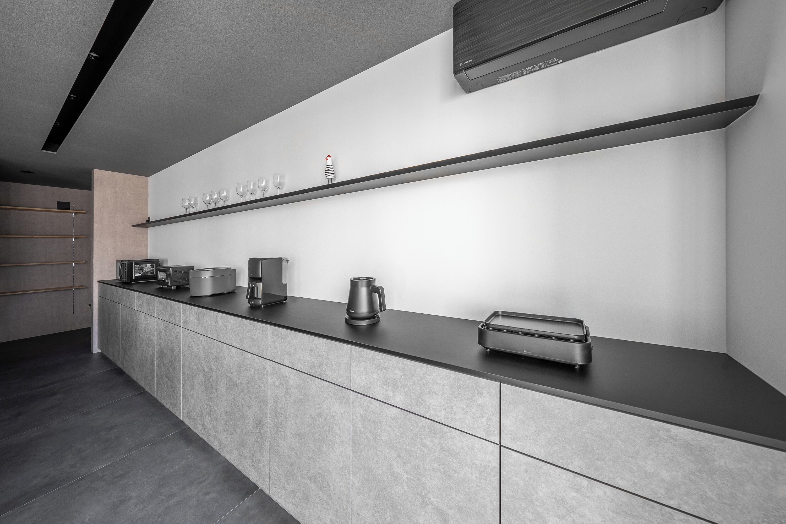 A modern kitchen with a sleek countertop, built-in appliances, and a minimalist design.