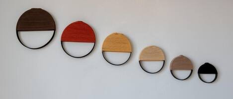 Six circular objects with varying colors and sizes arranged in a row on a plain background.