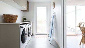 A laundry room with a washing machine, a drying rack, and a wicker basket. - South Launceston Gem, Minutes to Cataract Gorge (Launceston City)