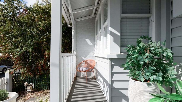A white porch with a striped floor, a potted plant, and a chair. - South Launceston Gem, Minutes to Cataract Gorge (Launceston City)