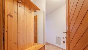 A wooden interior with a bench, a door, and a wall-mounted mirror. - Farm Stay Oblak Studio Ina + Shared Sauna, Ortnek, Slovenia (Ortnek)