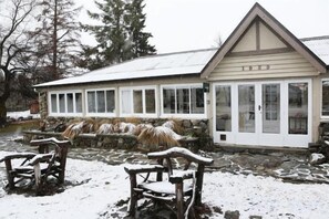 A building with a gabled roof and a stone foundation. - Tekapo1929 Lakefront Villa (Lake Tekapo)