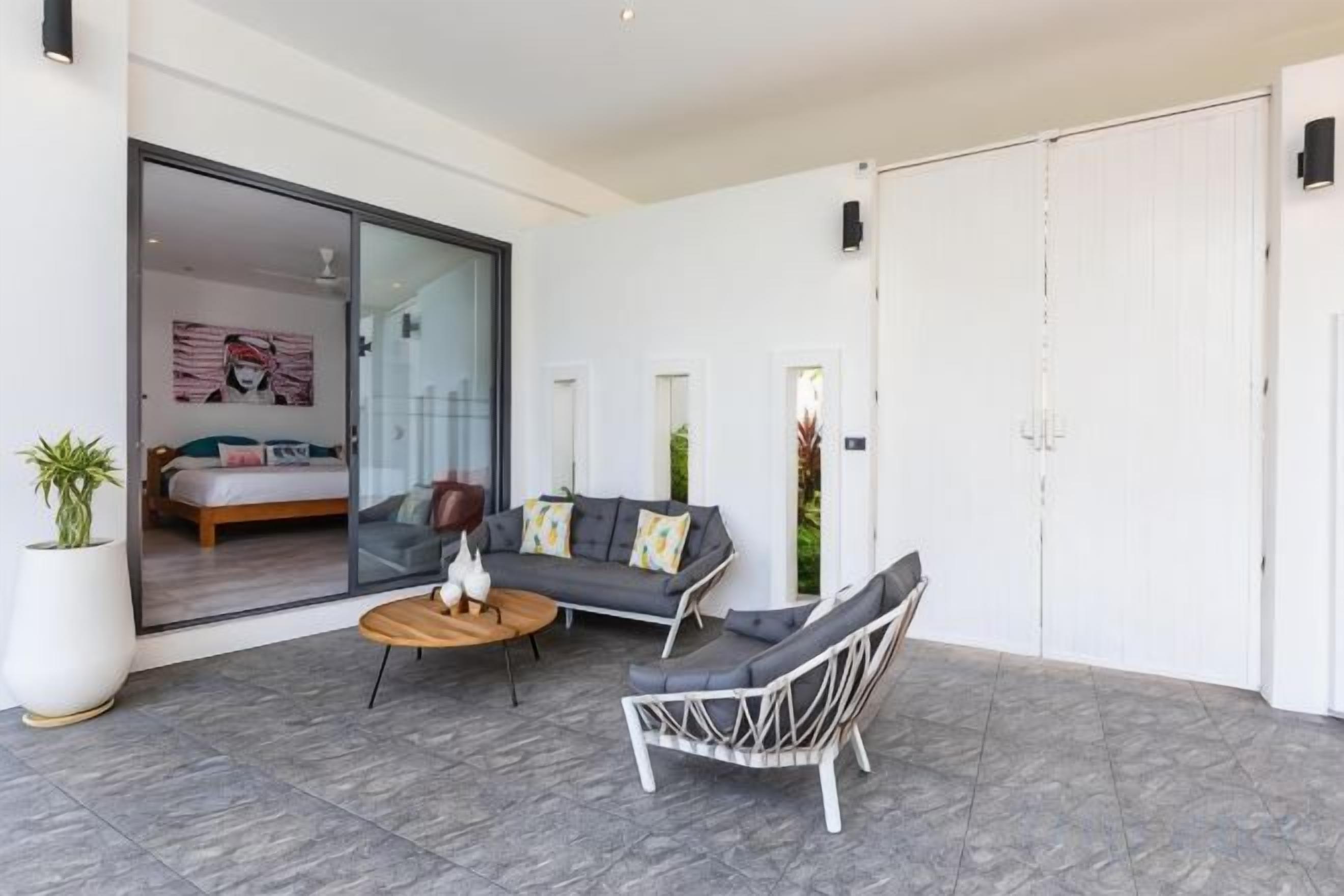 A modern interior with a sofa, a chair, and a small table.