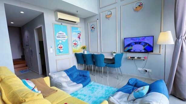 A modern living room with a sofa, chairs, a TV, and a dining area. - Doraemon @ Hyde Towel Duplex Fully AiCON 2BR (Shah Alam)