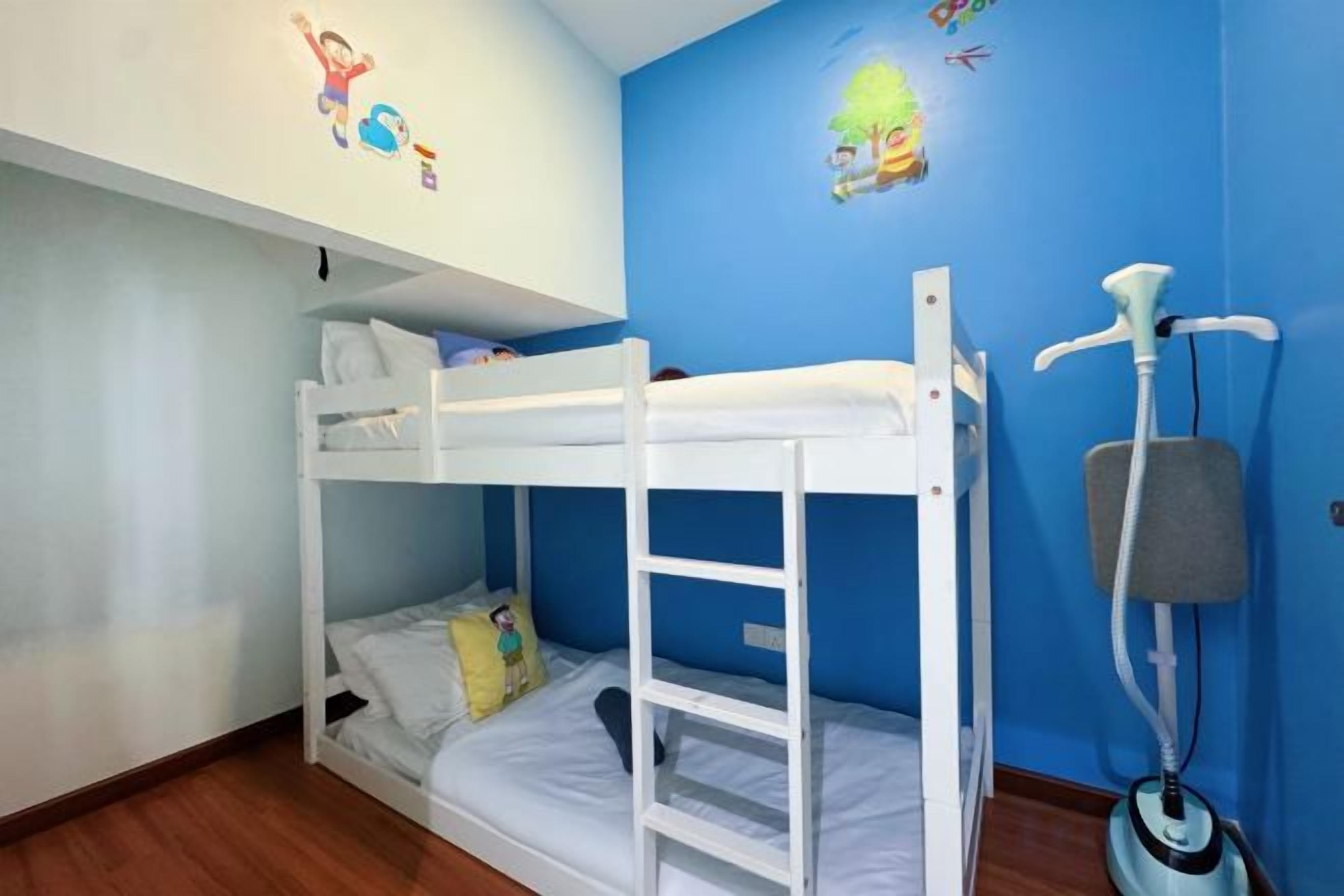 A bunk bed room with a standing fan and a cat tree.