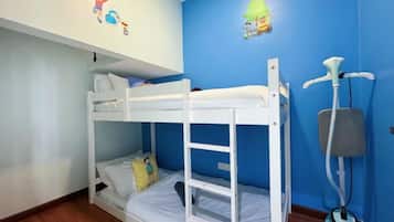 A bunk bed room with a standing fan and a cat tree.