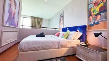 A bedroom with a bed, bedside tables, a nightstand, and a window with curtains.