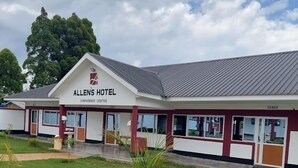 Allen's Hotel with a conference center, a well-maintained lawn, and a brick pathway leading to the entrance. - ALLENS HOTEL (Kapsabet)