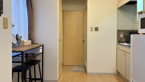 A compact kitchen with a wooden countertop, a sink, and a refrigerator. - Nestay apartment Tokyo Itabashi (Tokyo)