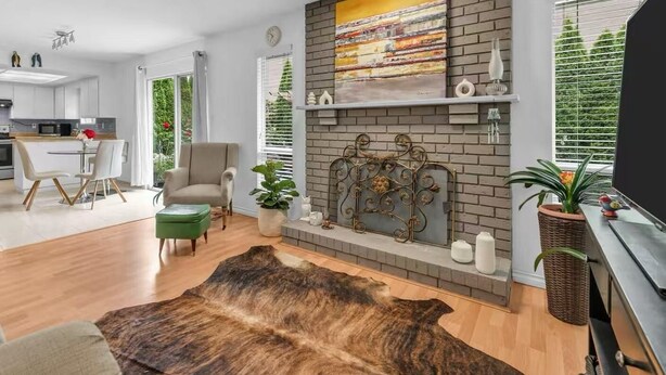 A modern living room with a fireplace, a dining area, and a kitchen in the background. - Private room in home Richmond, Canada
2 guests 1 bedrooms 1 in-suite bathrooms (Richmond)