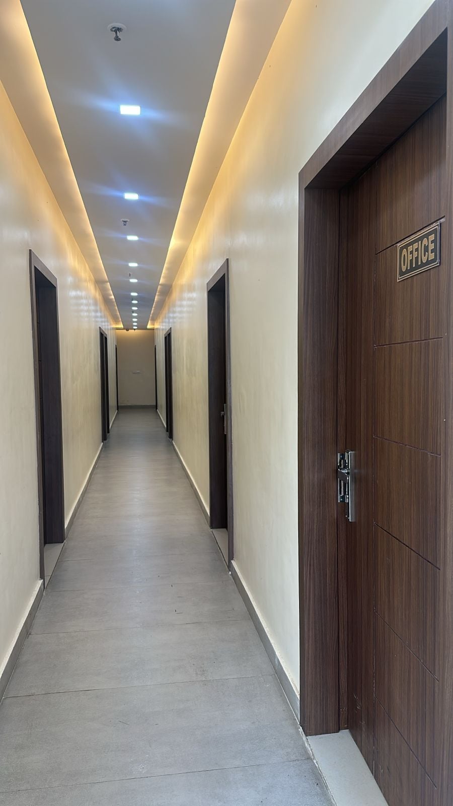 A long, narrow hallway with a wooden door labeled "OFFICE" on the right.