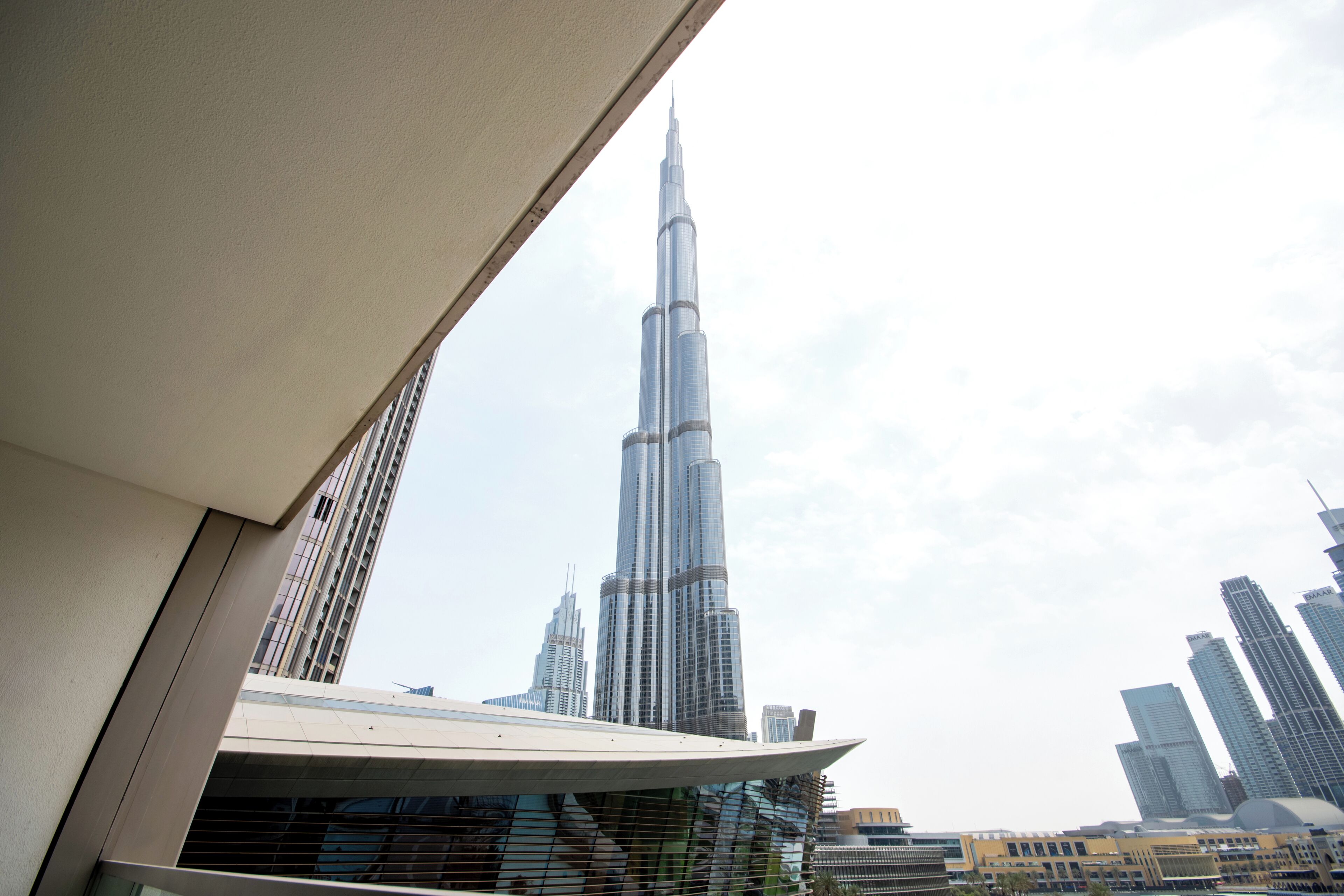 A high-rise building with a distinctive tapering design, surrounded by other modern skyscrapers.