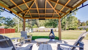 An outdoor patio with Adirondack chairs, a table, and a grill. - The Dome Home<>3BR House 1mi to ND (South Bend)