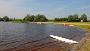 Une rivière avec des bateaux et une planche de surf sur la rive.