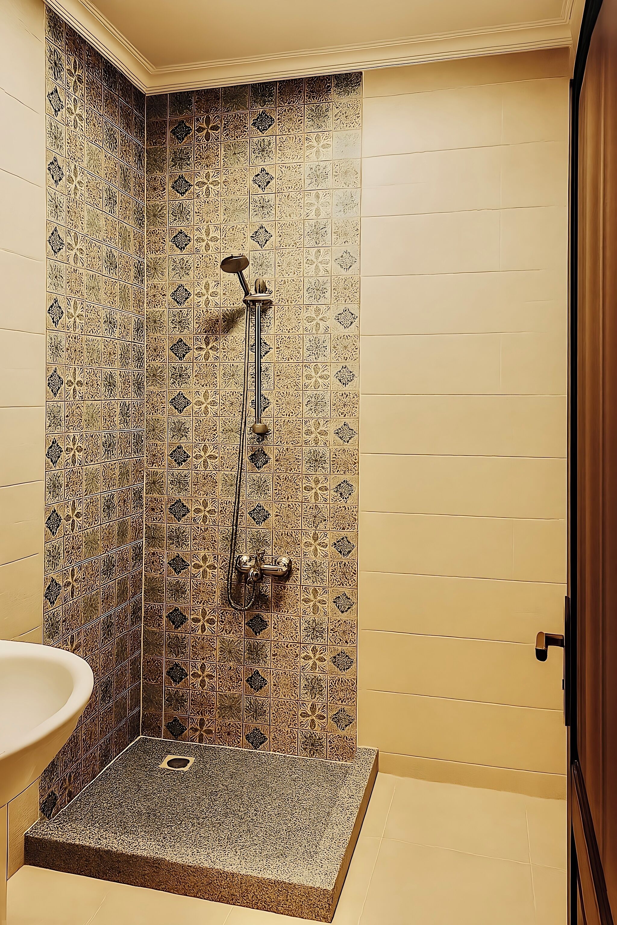 A bathroom with a shower, a sink, and a door.