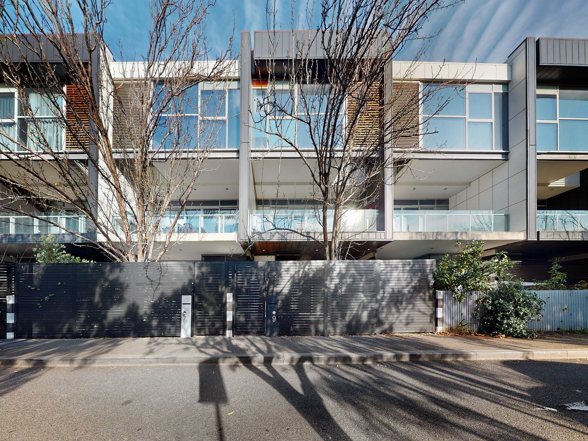 A modern building with a flat roof, large windows, and a concrete facade.