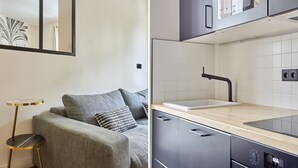 Une cuisine moderne avec un lave-vaisselle noir, un évier et un plan de travail en bois.