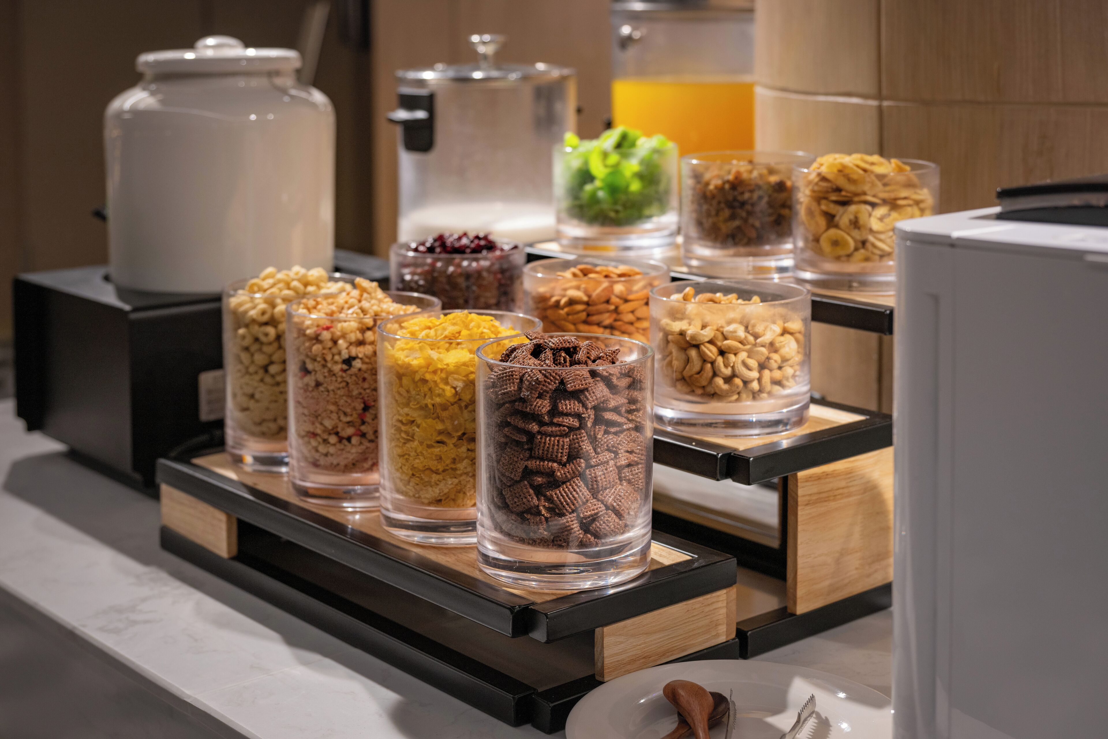 A breakfast buffet with various food items in clear containers.