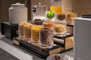 A breakfast buffet with various food items in clear containers.