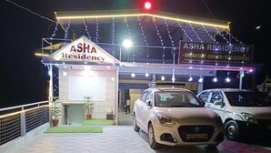 ASHA RESIDENCY with a car parked in front, a signboard, and string lights. - Asha Residency By St Hotel (Shimla)