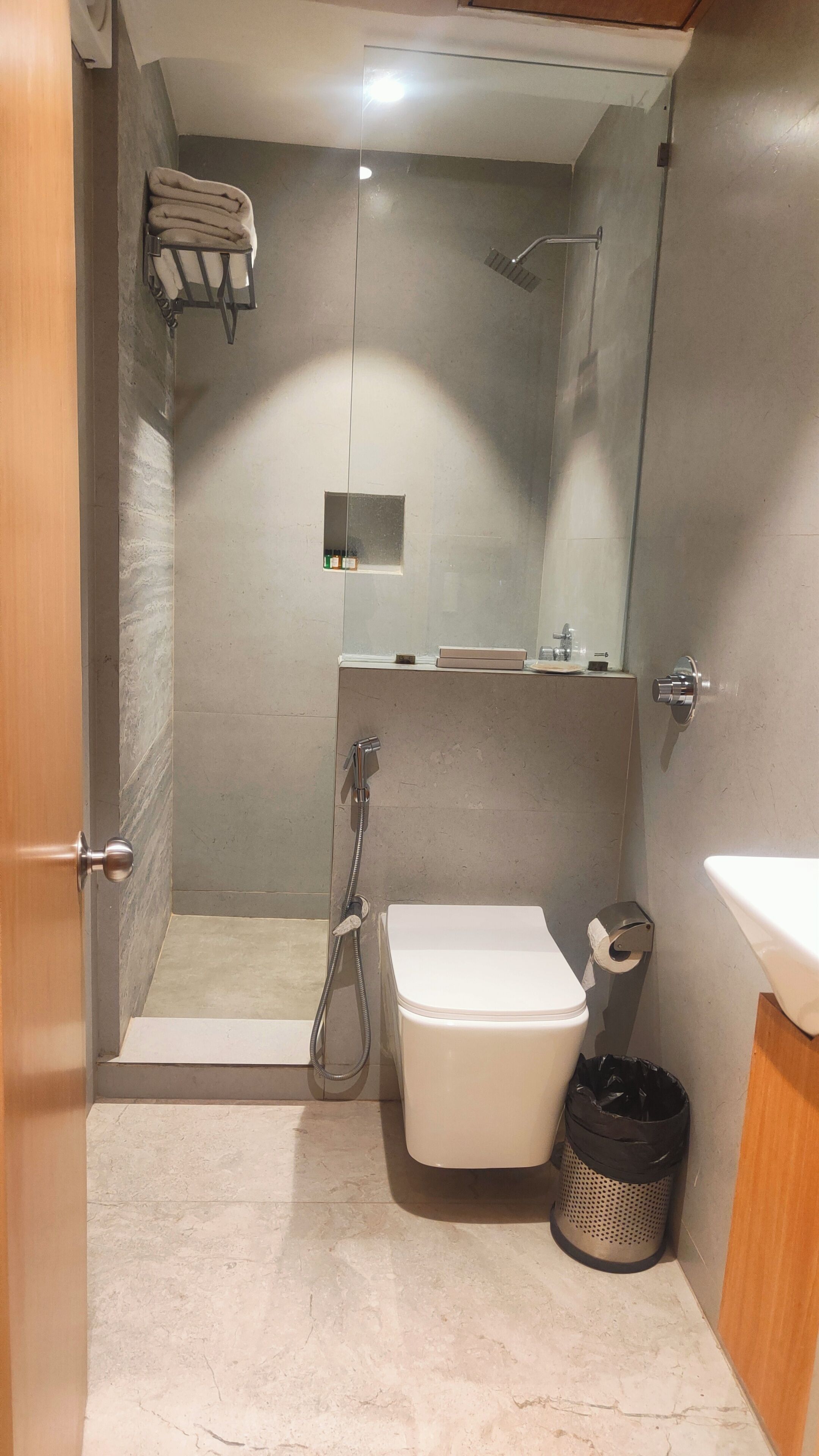 A bathroom with a shower, toilet, and sink.