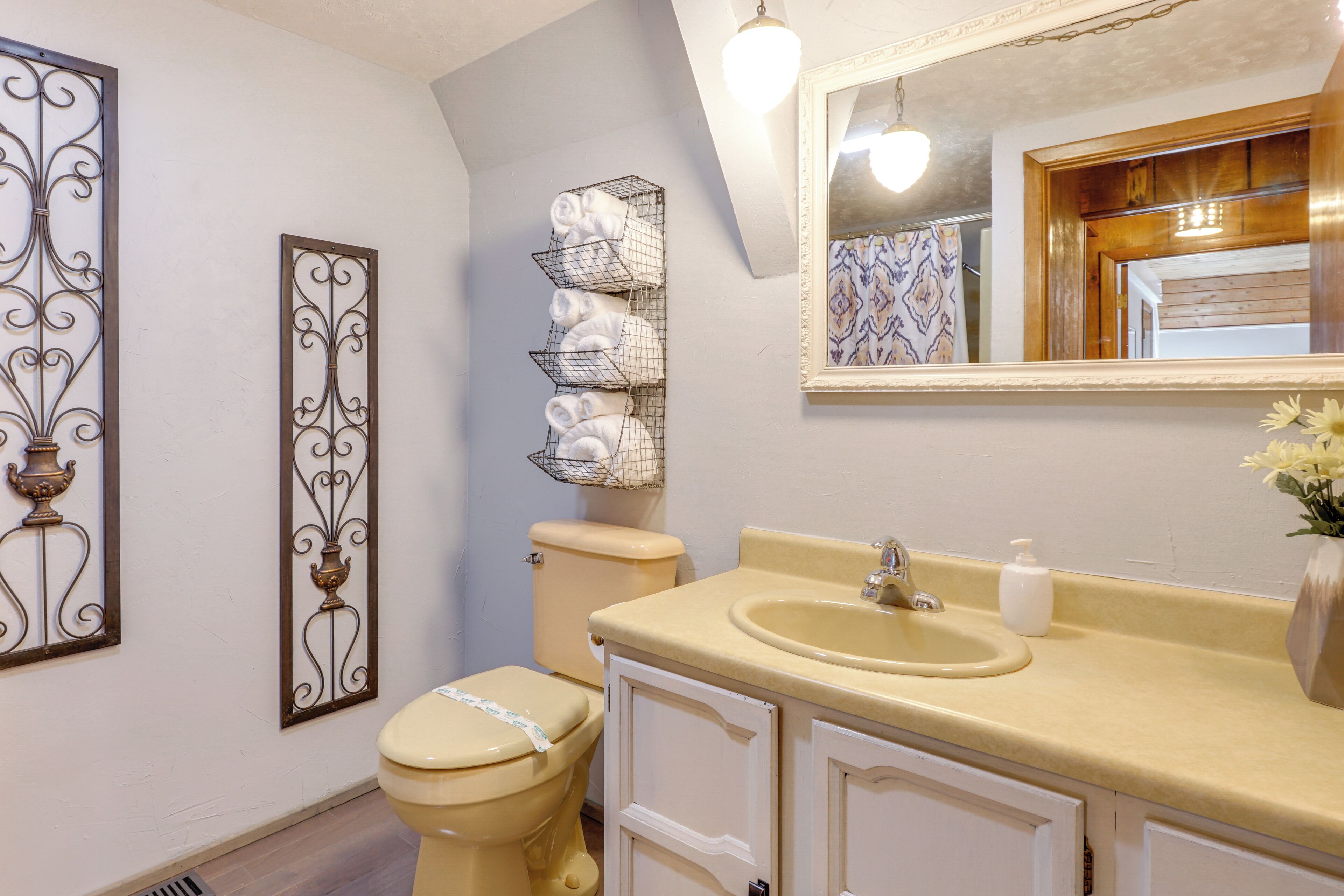 A bathroom with a toilet, a sink, and a towel rack.