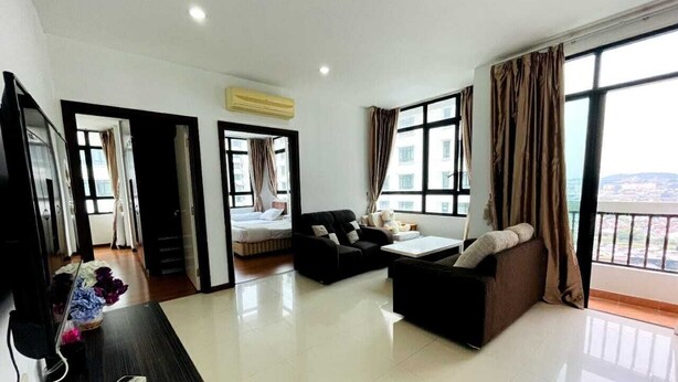 A modern living room with a sofa, a coffee table, and a TV. There is a balcony with curtains and a view of the city. - Lake view Resisdence (Seri Kembangan)